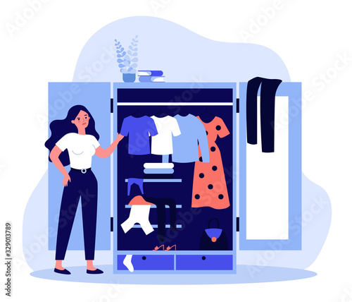 Woman standing near opened closet and looking at dresses flat vector illustration. Pile of clothes laying in wardrobe. Organization and arrangement concept.