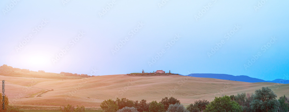 Tuscany, rural landscape. Rolling hills, countryside farm, cypresses trees, green field on warm sunset. Italy, Europe. Tuscany, rural landscape. Rolling hills, countryside farm, cypresses trees, green field on warm sunset. Italy, Europe.