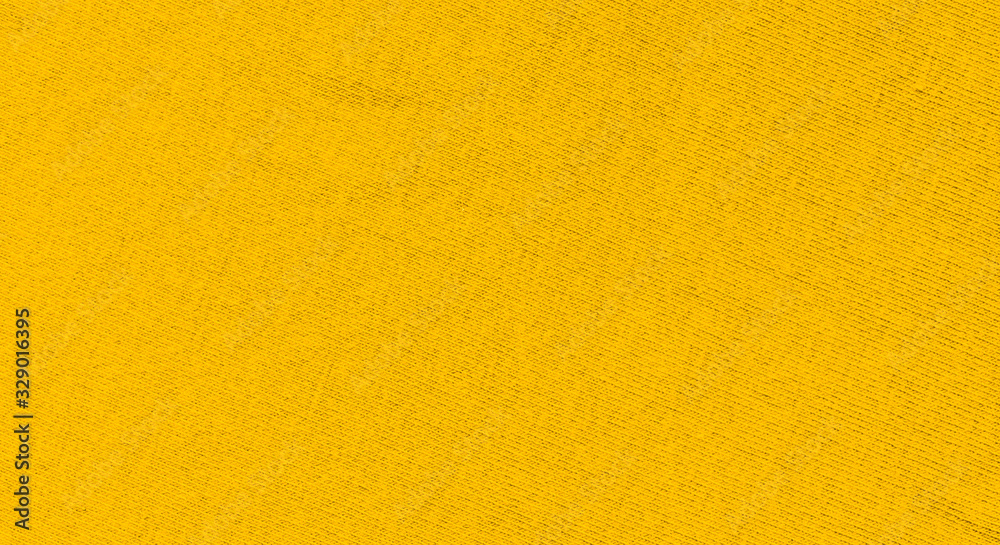 Vibrant yellow texture of binding fabric. Yellow textile background with natural folds. Close-up Vibrant yellow texture of binding fabric. Yellow textile background with natural folds. Close-up