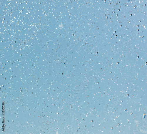 Drops of water on a blue glass window