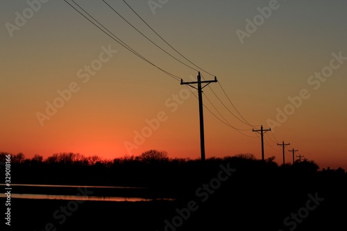 Kansas Sunset with Power Line silhouettes. © Stockphotoman