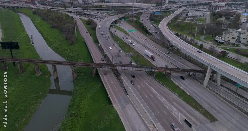 Aerial view of traffic on freeway near downtown Houston on a cloudy day during sunset. This video was filmed in 4k for best image quality. Aerial view of traffic on freeway near downtown Houston on a cloudy day during sunset. This video was filmed in 4k for best image quality.