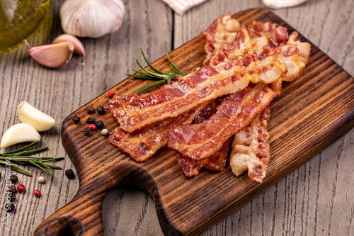 Closeup of slices of crispy hot fried bacon photo
