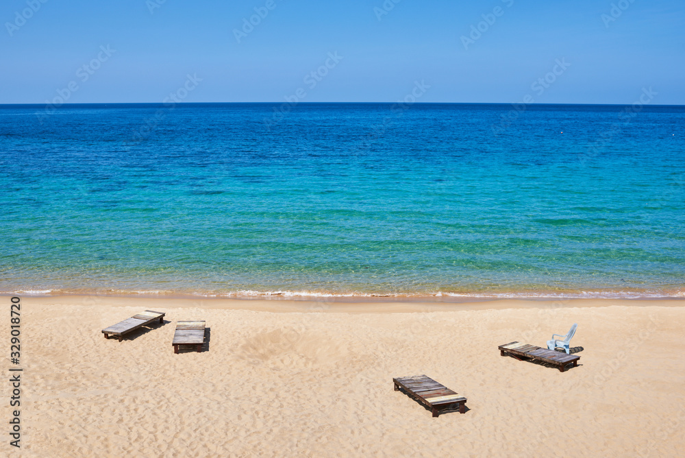 Gold sand beach and turquoise sea background. Coastline on sunny day background of sea and sky, gold sand, tourism, relax, vacation, summer, ocean. Tioman Island, Malaysia. Gold sand beach and turquoise sea background. Coastline on sunny day background of sea and sky, gold sand, tourism, relax, vacation, summer, ocean. Tioman Island, Malaysia.