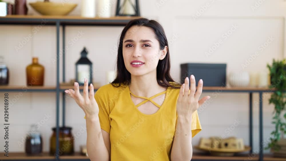 Stressed girl squinting eyes and gesturing emotionally at home Stressed girl squinting eyes and gesturing emotionally at home