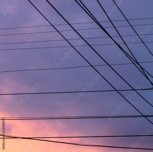 Wires against the sky with clouds