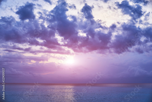 Sunset clouds. The beauty of the sunset. Amazing beach sunset with endless horizon. Sunrise over sea with clouds and horizon in the distance. Nature landscape background with copy space for text.