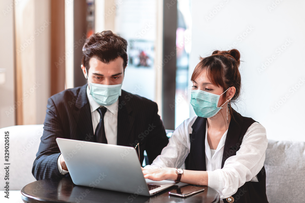 Businessman and Businesswoman Wearing Protective Mask for Protect from Air Pollution, Environmental Awareness and Coronavirus (COVID-19) Outbreak.They Working with Colleagues in an Office Businessman and Businesswoman Wearing Protective Mask for Protect from Air Pollution, Environmental Awareness and Coronavirus (COVID-19) Outbreak.They Working with Colleagues in an Office