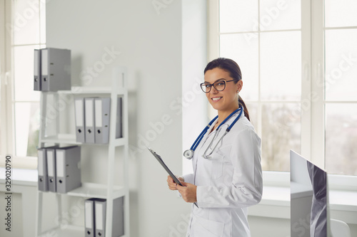 Woman doctor pediatrician standing in the white office of the hospital.