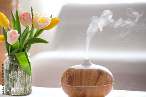 Aroma oil diffuser lamp on the table .