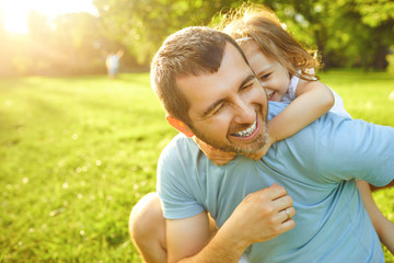 Father's day. Father plays with his daughter in the summer park.