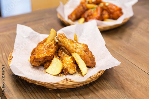 Golden Crunchy Korean Garlic Fried Chicken Wings (basic Huraideu-Chikin) served fried potato with peel. In South Korea, fried chicken is consumed as a meal, an appetizer.