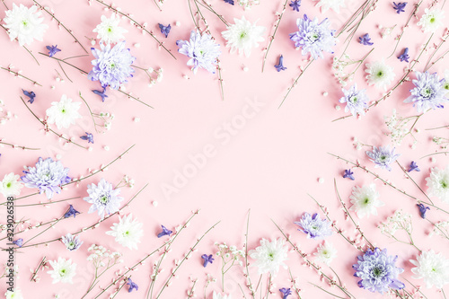 Flowers composition. White and purple flowers on pink background. Spring concept. Flat lay  top view  copy space