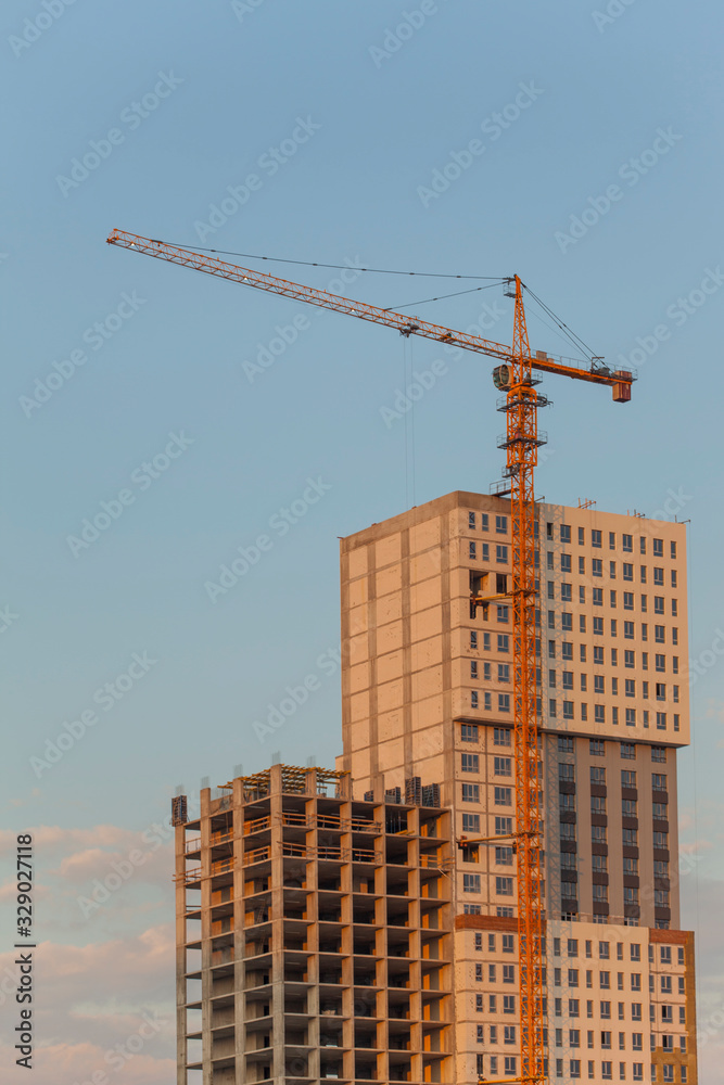 Construction site with crane against the blue sky