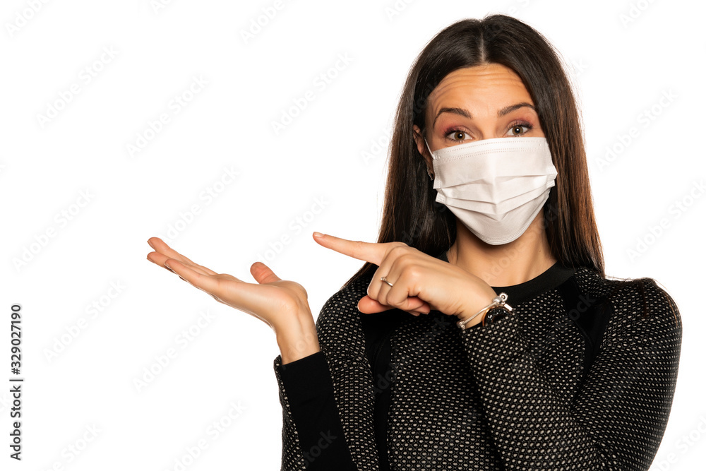 Beautiful advertizing young woman with protective mask on her face on white background Beautiful advertizing young woman with protective mask on her face on white background