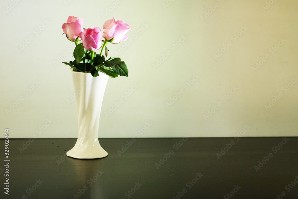 Fototapeta premium Three pink roses in classic vase on white background