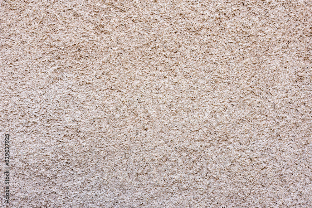 Close-up of a texture fragment of a decorative wall plaster on a building wall Close-up of a texture fragment of a decorative wall plaster on a building wall