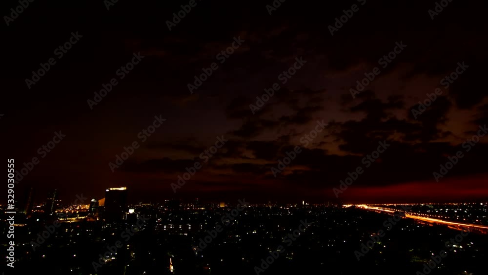 A wide angle shot of a sunset taken in a less populated part of Bangkok. a cloudy afternoon and car lights are coming out after sunset. A wide angle shot of a sunset taken in a less populated part of Bangkok. a cloudy afternoon and car lights are coming out after sunset.