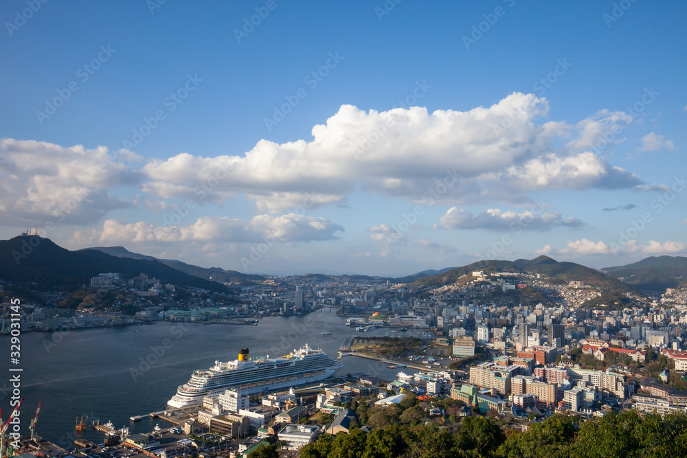 Nabekanmuri Park Observation Platform city in Japan, High angle view of Nagasaki park. Garden, nature and city view, seaside city in asia with harbor and boat on blue sea, observatory of the bay. 