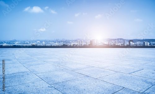 Empty square floor tiles and Qingdao urban architecture skyline.. © 昊 周