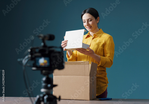 Vlogger making an unboxing video for her channel photo