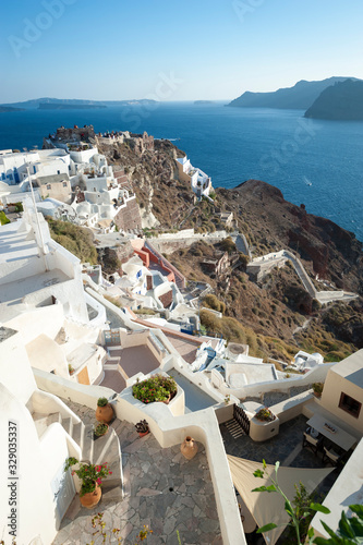 Sunny afternoon landscape view of the Mediterranean hillside village of Oia in Santorini, Greece