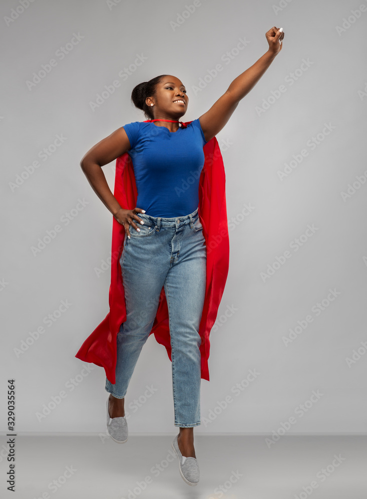 Φωτογραφία women's power and people concept - happy african american woman in red superhero