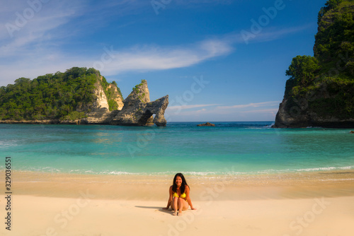 young happy and attractive Asian Korean woman in bikini excited at paradise beach sitting on sand by the sea enjoying idyllic Summer holidays at beautiful tropical island © TheVisualsYouNeed
