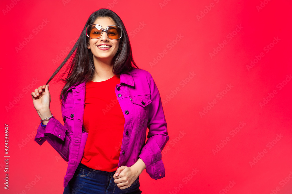 Beautiful Asian girl on a bright, red background. The concept of a bright and cheerful, active life. Beautiful Asian girl on a bright, red background. The concept of a bright and cheerful, active life.