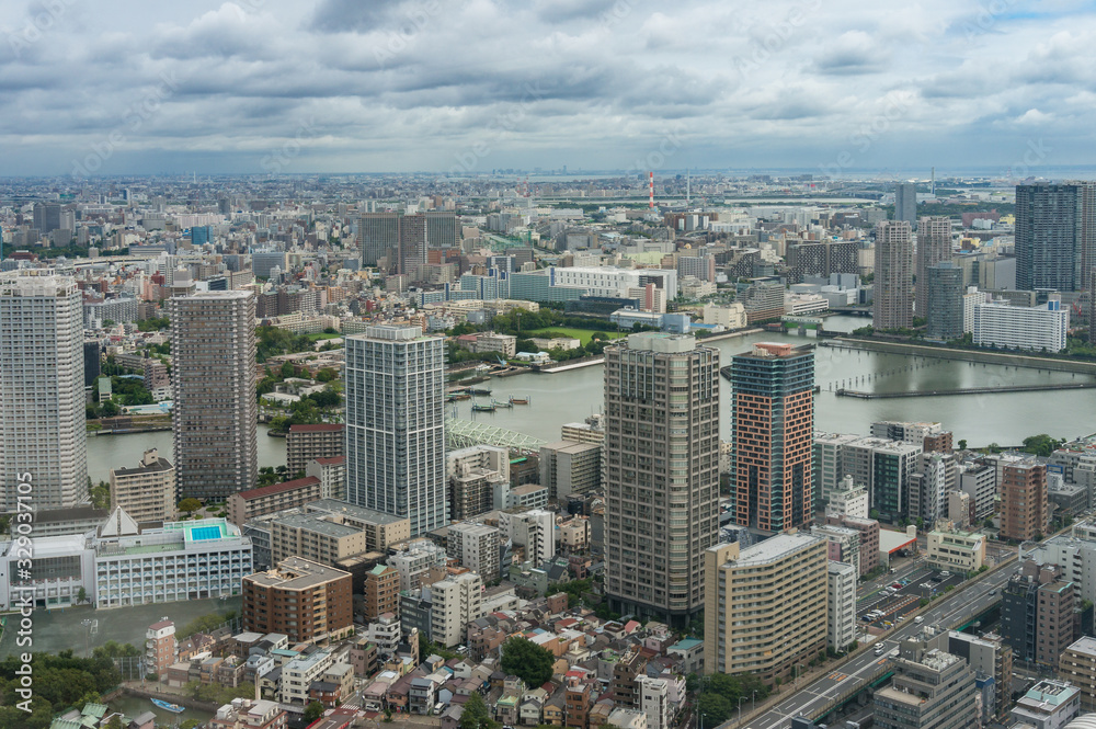 Tokyo cityscape aerial drone shot with skyscrapers and river