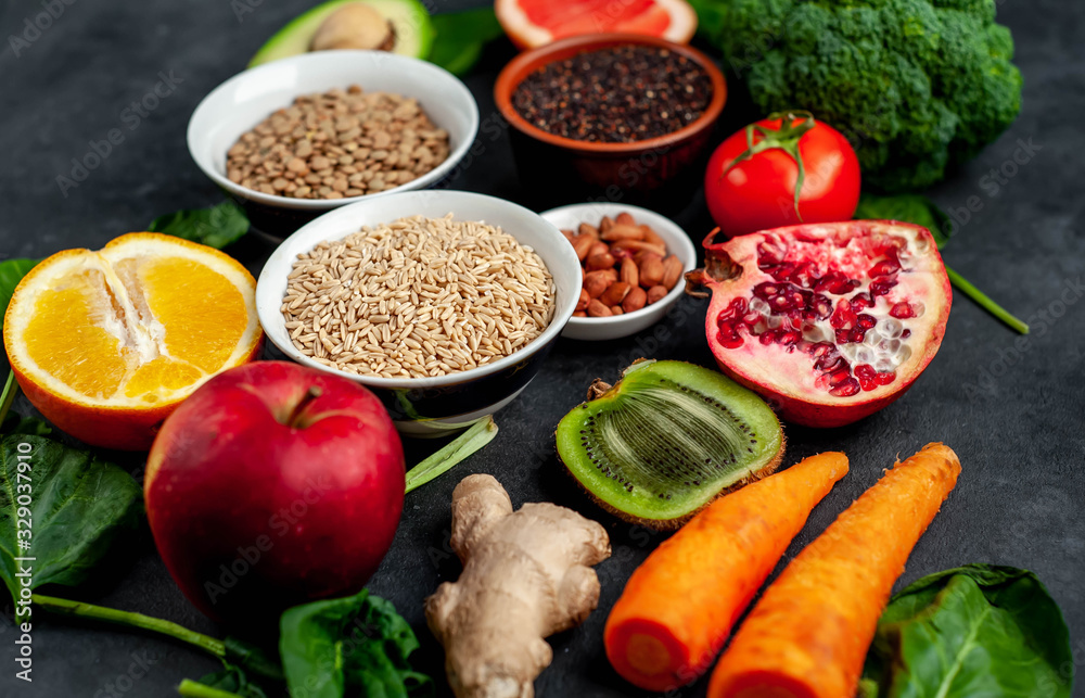 Selection of healthy food: fruits, seeds, cereals, superfoods, vegetables, leafy vegetables on a stone background. Healthy food for humans Selection of healthy food: fruits, seeds, cereals, superfoods, vegetables, leafy vegetables on a stone background. Healthy food for humans