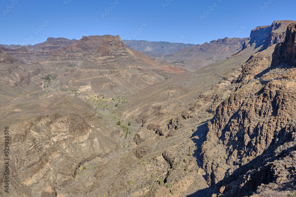 Scenic view of canyon among mountains in the center of Gran Canaria island in Canary islands in Spain. Beautiful summer sunny look of landscape of paradise island in Atlantic ocean.