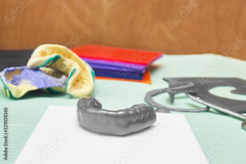 Wallpaper Mural Process of creating custom mouthguard. Silver sports mouthguard with pieces of plastic material and tools. Torontodigital.ca