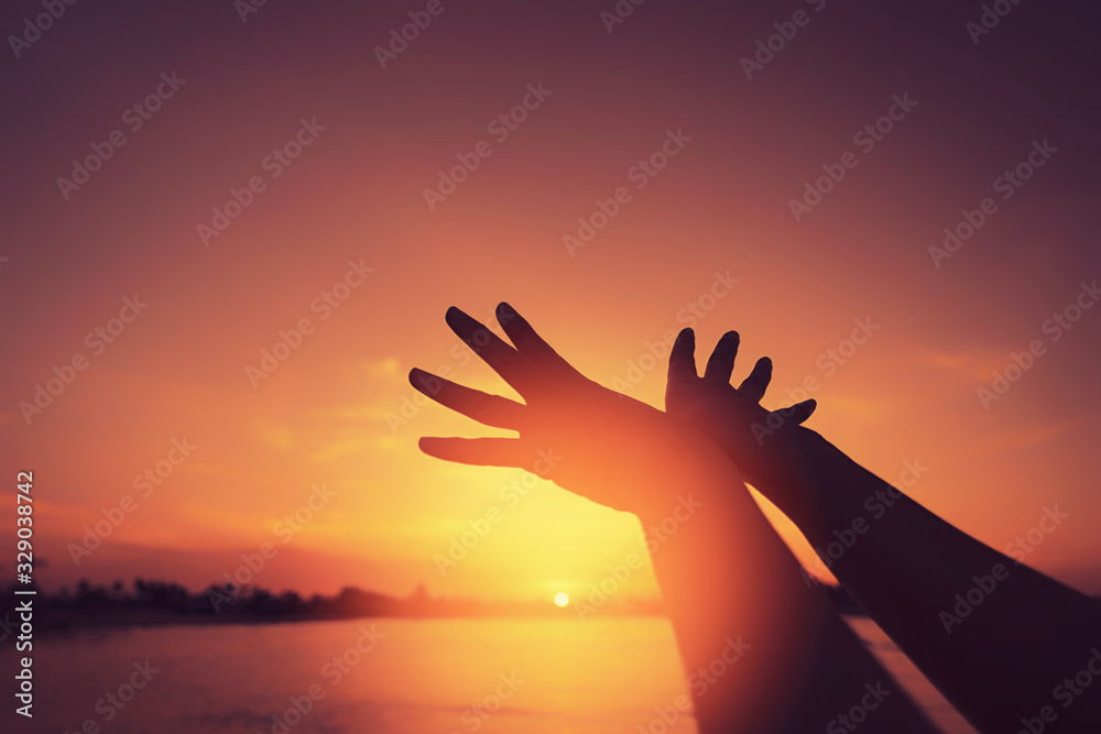 Woman raise hand up like bird shape at tropical sunset beach abstract background. Freedom feel good and travel adventure concept.