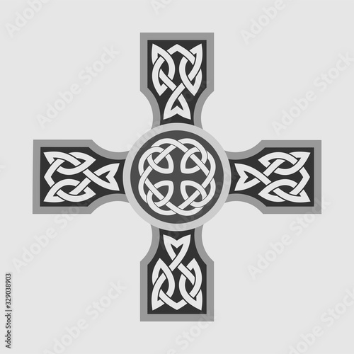 Celtic ornament in the shape of a cross. Isolated vector on a light background.