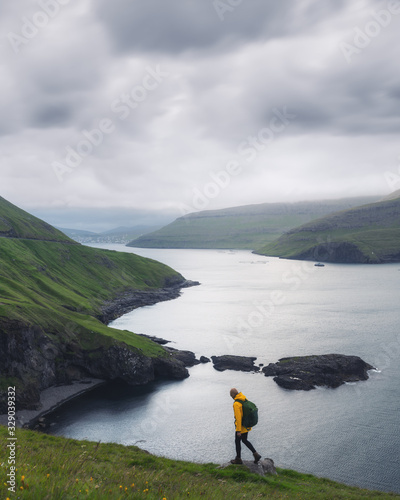Dramatic view of green hills of Vagar island and Sorvagur town on background. Faroe islands, Denmark. Landscape photography