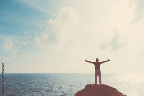 Copy space of man raise hand up on blue sky at beach and island background.