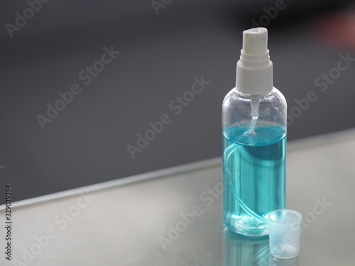 Alcohol 75% in a spray bottle placed on the table, prevent germs protect virus covid 19 photo