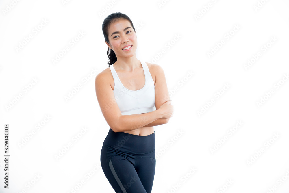 a beautiful asian sporty woman wear black and white outfit standing and posing  on white background.fitness lady smile with winning and successful feeling