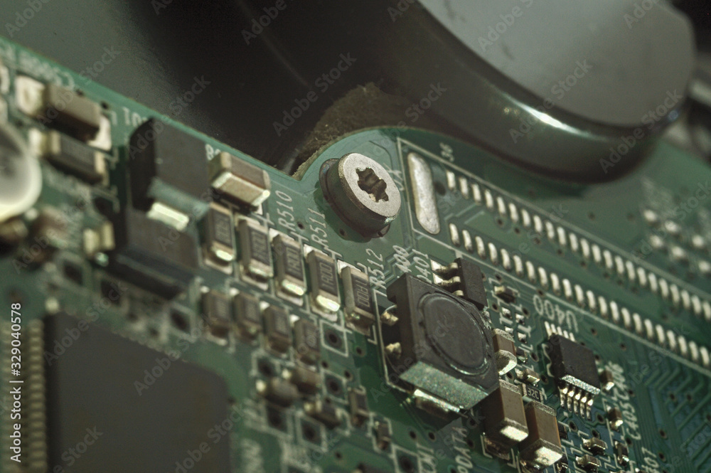 Fototapeta premium Micro circuit board bolt retainer close-up repair computer background engineering.