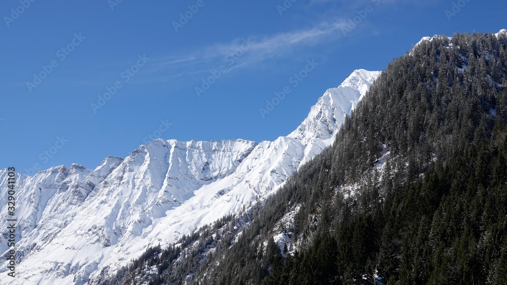 beautiful sunny day with clear blue sky in the snow capped alps in austria