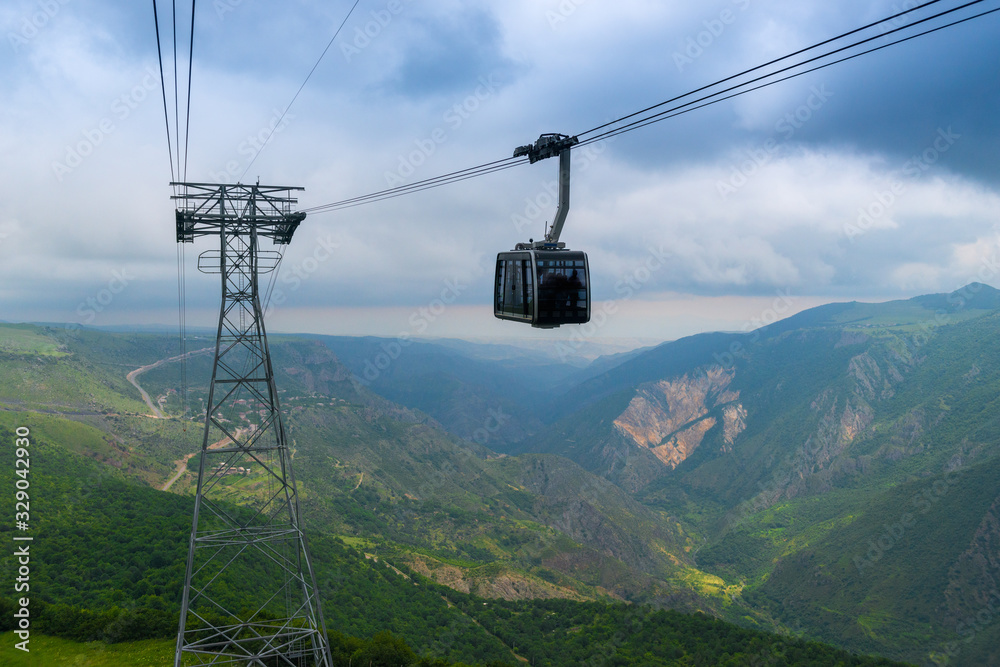 Cableway and support against the backdrop of the picturesque mountains of Armenia near the Tatev Monastery - a landmark of Armenia