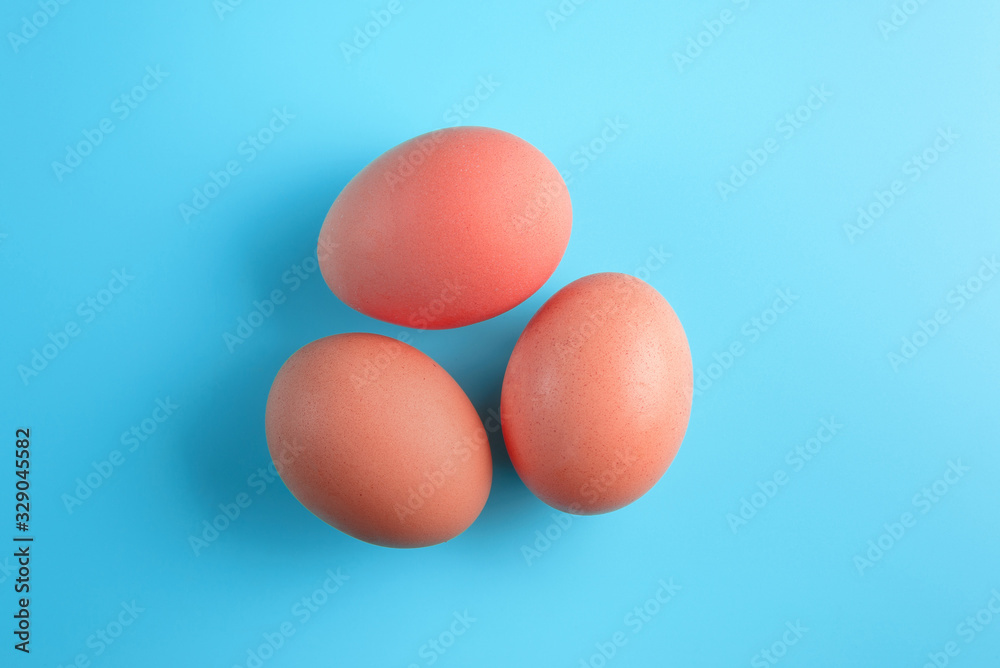 Three red easter eggs on blue surface. Colorful easter eggs decoration. Flat lay, top view. with copy space for text. Three red easter eggs on blue surface. Colorful easter eggs decoration. Flat lay, top view. with copy space for text.