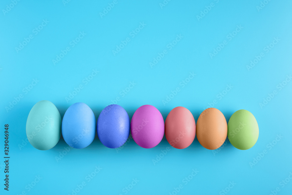 Seven easter eggs on blue surface. Colorful easter eggs decoration. Flat lay, top view. with copy space for text Seven easter eggs on blue surface. Colorful easter eggs decoration. Flat lay, top view. with copy space for text
