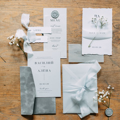 Layout of lashes with flowers on the table. Printing to the wedding. Wedding invitations in the set.