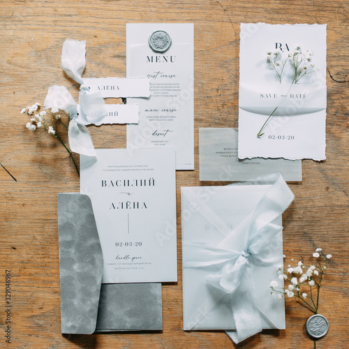 Layout of lashes with flowers on the table. Printing to the wedding. Wedding invitations in the set.