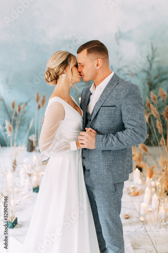 Wedding couple in an autumn decor. Ceremony in the style of fine art in the room. Wedding ceremony in the interior Studio. © pavelvozmischev