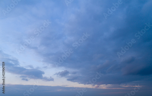 Evening blue sky with moderate clouds.