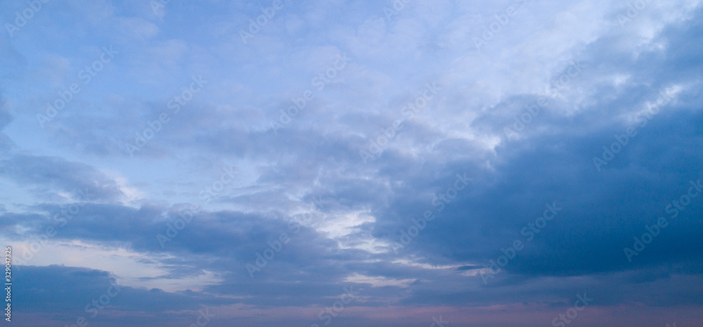 Evening blue sky with moderate clouds.