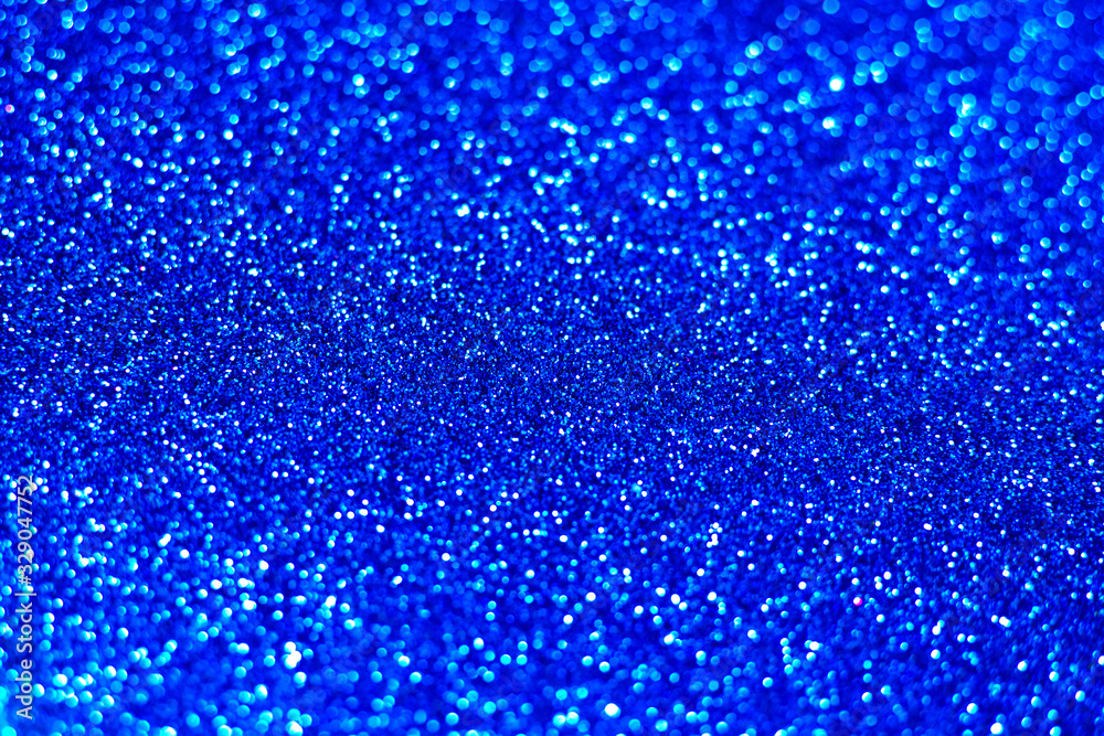 Blue classic sparkle background. Bright navy blue texture. Selective focus.